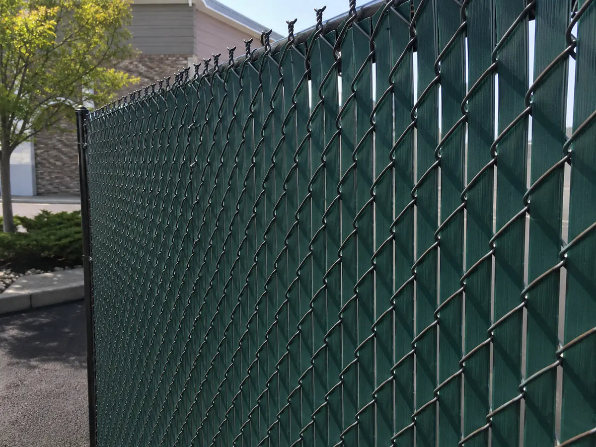 Chain link fence with green privacy slats